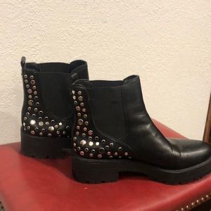 Black ankle boots with silver charms